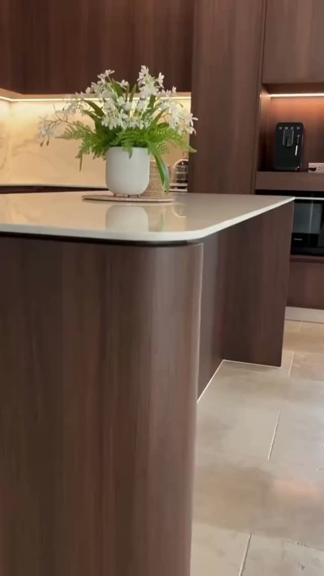 Кухня в теплых древесных тонах с округлым островом