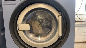 Miele Professional PW6080 commercial washing machine running a quick wash programme with towels.