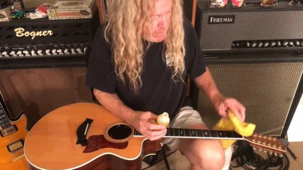 Cleaning guitar fretboard with Lemon Oil Compound.