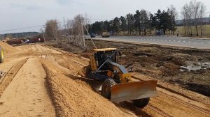 Планировка откосов насыпи автогрейдером JONNDEER ЦКАД