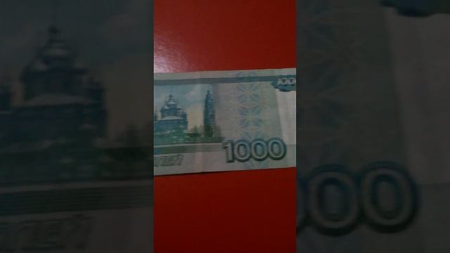 ОДНА БАНКНОТА 1000 РУБЛЕЙ RU обратной стороной на бордовой поверхности Двадцатого Ноября смотреть онлайн