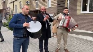 an orchestra is played at an Armenian wedding, a clarinet accareon drum