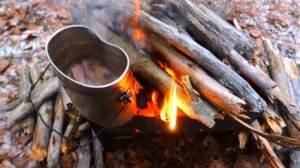 Bushcraft camp in forest,winter outdoor camping,cooking on the campfire.