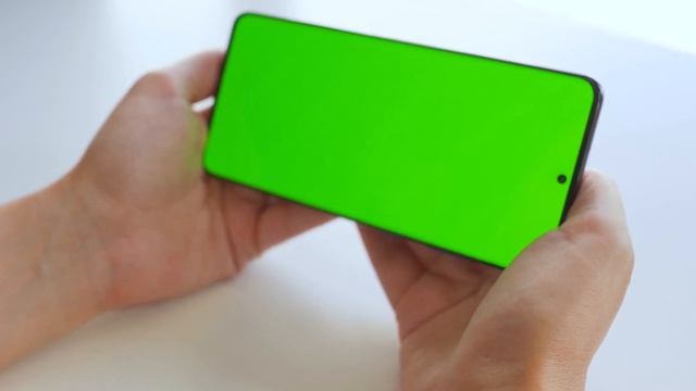 female hands using a smartphone with a green screen in horizontal mode chroma key stock footage смотреть онлайн