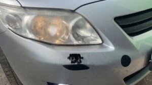 Крышка форсунки омывателя фар и Заглушка буксировочного крюка на Toyota Corolla E150