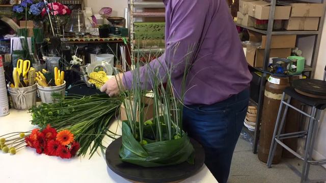 Natural Style Table Centre - With Mini Gerbera And Beargrass - смотреть онлайн
