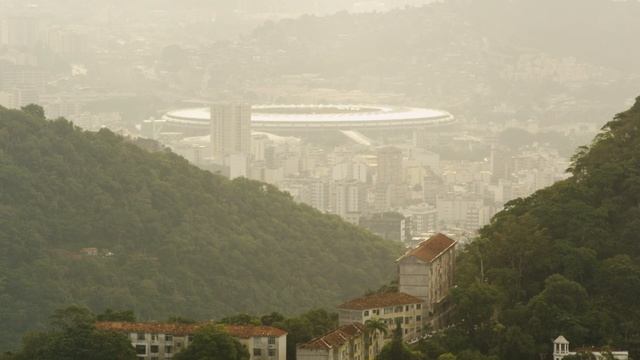Pan footage of hills and houses of Rio, Maracanã stadium смотреть онлайн