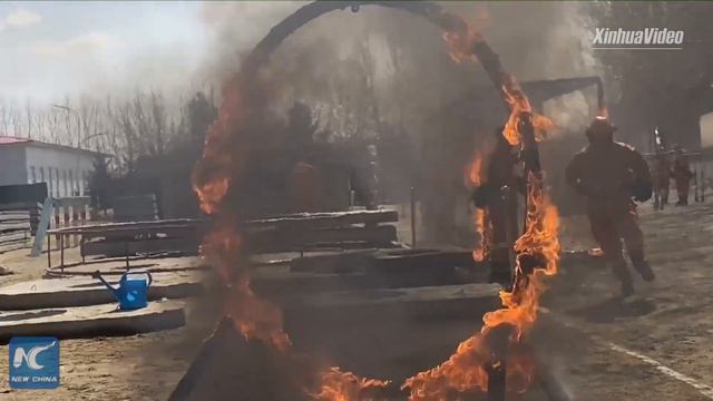 Jumping Through Fire! Firefighters Undergo Training In China's Harbin