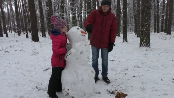 Funny dog Jack Russell Terrier Hilda hunts for a carrot of a snowman. The dog is eating carrots