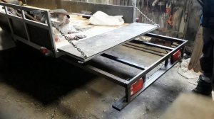 Раздвижной задний борт на легковом прицепе.