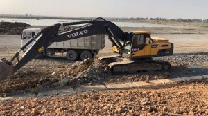 The Volvo EC300DL Excavator Loading Mercedes & MAN Trucks in Construction Development Area.
