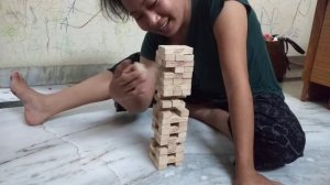 Cute two girls playing Jenga game at home