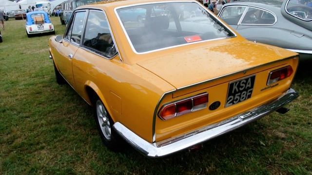 A 1964 Fiat 124 Sport Coupe parked on display смотреть онлайн