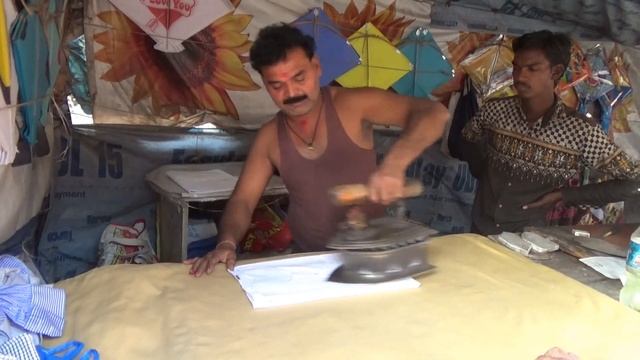 Roadside "Ironing Wallah" who uses an Antique Coal Iron to Iron Clothes at his Shop, Bardoli, India смотреть онлайн