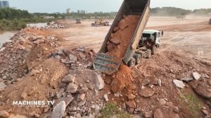 Huge Land Reclamation Process Dump Truck Management Unloading Rock Dirt Bulldozer Pushing Stone