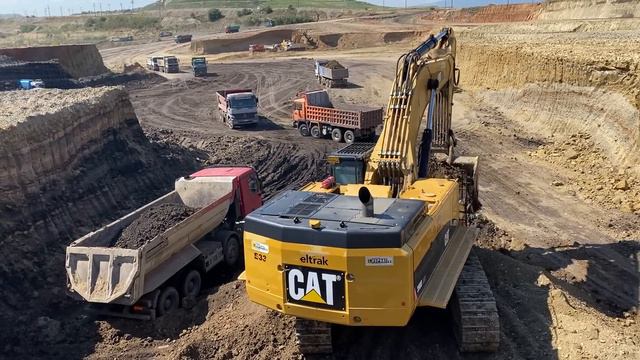 Caterpillar 390D Excavator Loading Trucks