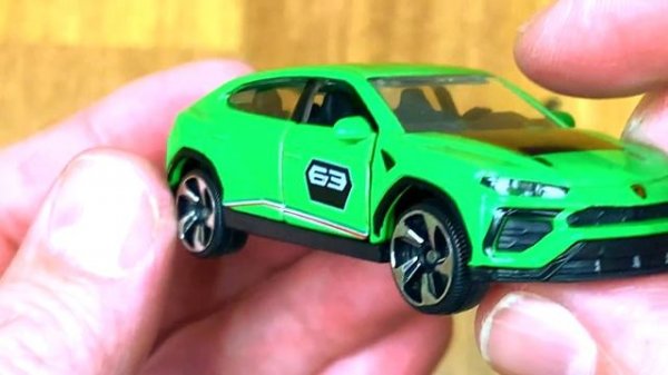 Collection of Diecast Cars Reviewed in Hands - green car, red car, yellow car