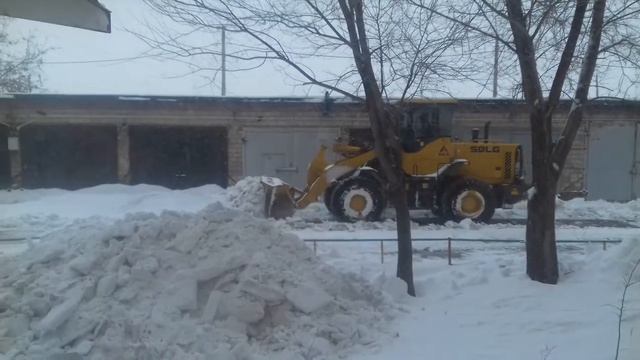Фронтальный погрузчик очищает от снега. смотреть онлайн