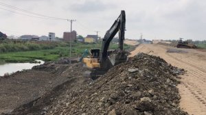 The Volvo Excavator EC250 DL Digging And Excavation Preparing slope for road construction.