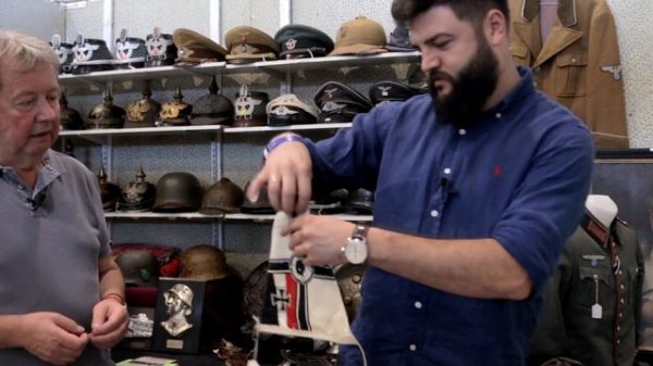 WW2 German vehicle flags and British navy dagger. Military antiques show Grossmering.