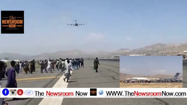 Kabul International Airport, Afghan People Are Running Along A U.S Aircraft And Hanging Onto Its