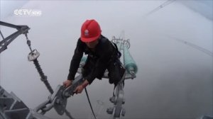Men on wire: Power workers walk in the clouds to repair lines
