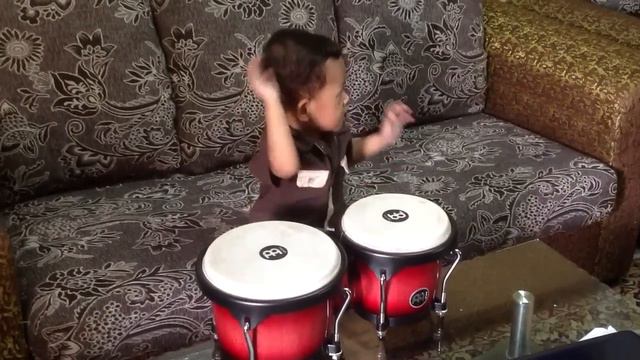 A Young Kid Playing With Bongo смотреть онлайн
