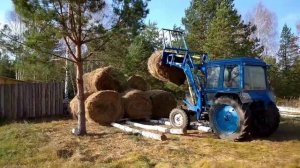 Трактором МТЗ сбор скирды из рулонов сена