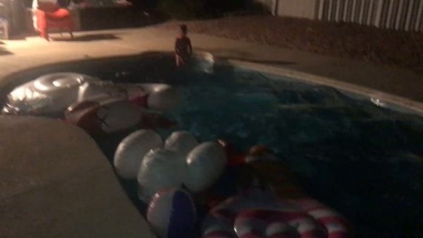 Swimming Kids Video At Night Time. Girls Having Fun In The Swimming Pool