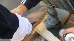 Shoeshine work on suede moccasin in Italy
