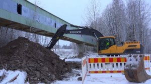 Volvo Ec250Dl Excavator in winter big machines work icy sand