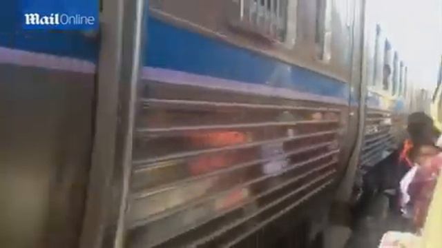 Railway line runs through streets so narrow the train squeezes past shop fronts and traders смотреть онлайн