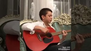 Парень поёт под гитару.