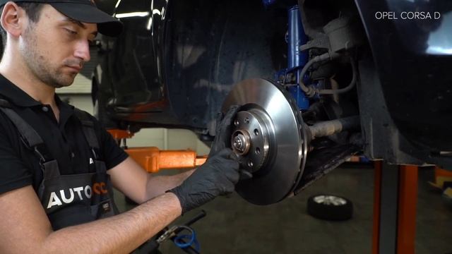 How to change front brake discs on OPEL CORSA D [TUTORIAL AUTODOC] смотреть онлайн