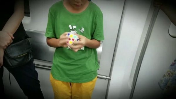 A Chinese kid solves Rubik's cube in less than a minute. Мальчик быстро собирает Кубик Рубик