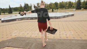 Beautiful girl businesswoman barefoot with shoes and a folder in his hands after a hard day of
