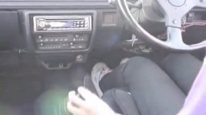 Girl driving stick shift in sneakers (pedal view)
