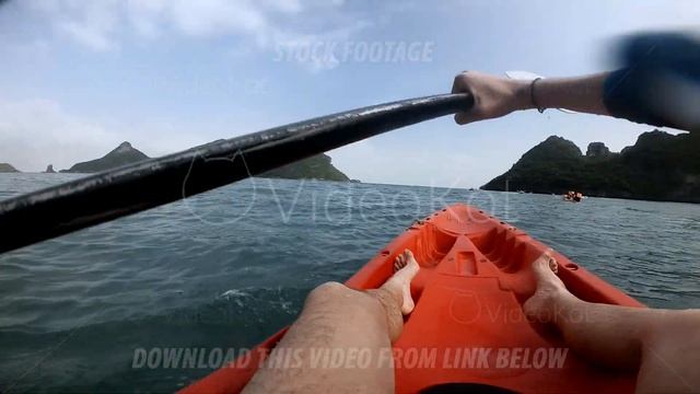 Man moving black oar to make kayak swimming near the green islands смотреть онлайн