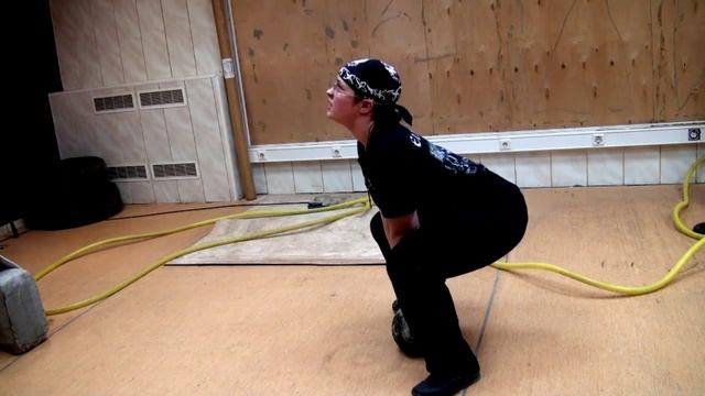 Приседания с гирей.