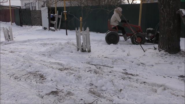 Девушка убирает снег при помощи мотоблока. /girl cleans snow with a garden bulldozer смотреть онлайн