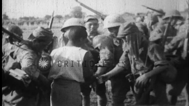 Natives provide water and refreshments to Japanese soldiers in Burma during the B...HD Stock Footag смотреть онлайн