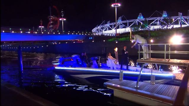 David Beckham & Sir Steve Redgrave Pass Olympic Torch - London 2012 Opening Ceremony