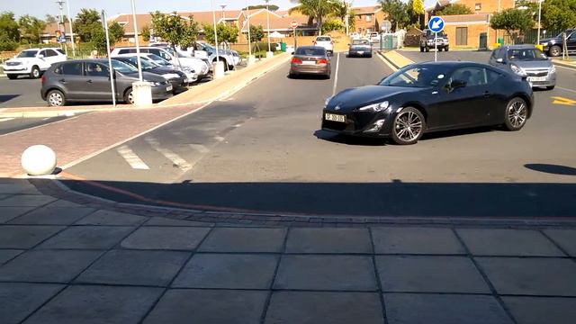 Black Toyota 86 and import Honda Accord driving by. смотреть онлайн