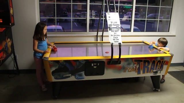 Brianna and Burke play air hockey while the other kids try arcade games at R&B Sportsworld смотреть онлайн