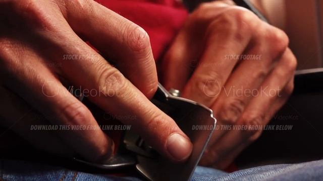 Macro view of young caucasian male hands fastening seat belt in the airplane смотреть онлайн