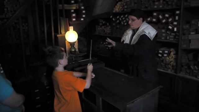 A wand chooses a boy inside Ollivanders Wand Shop in The Wizarding World of Harry Potter смотреть онлайн