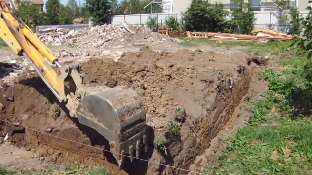 Tractor - excavator JCB 3CX digging trench strip foundations of a residential building. смотреть онлайн