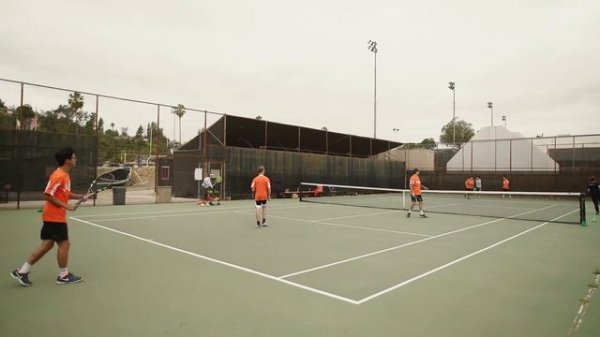 High school tennis lesson for boys varsity group, California.