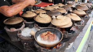 Курица и рис в глиняном горшочке на углях — уличная еда Малайзии. Куала-Лумпур