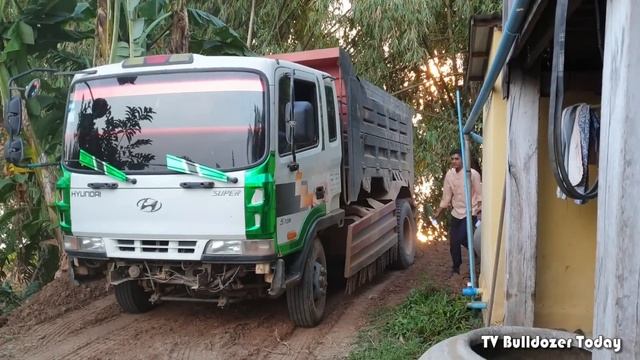 Good new project, KOMASTU Dozer activity and 5 ton dump truck pouring soil behind the house смотреть онлайн